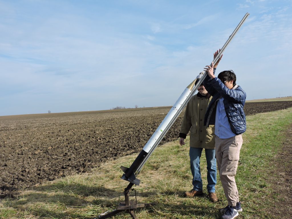 SL lifting rocket Two students lift a launch rail with a rocket on it