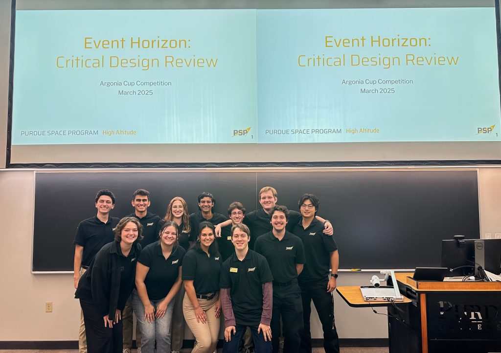 HA Event Horizon CDR Twelve students standing together in front of screens reading Event Horizon Critical Design Review