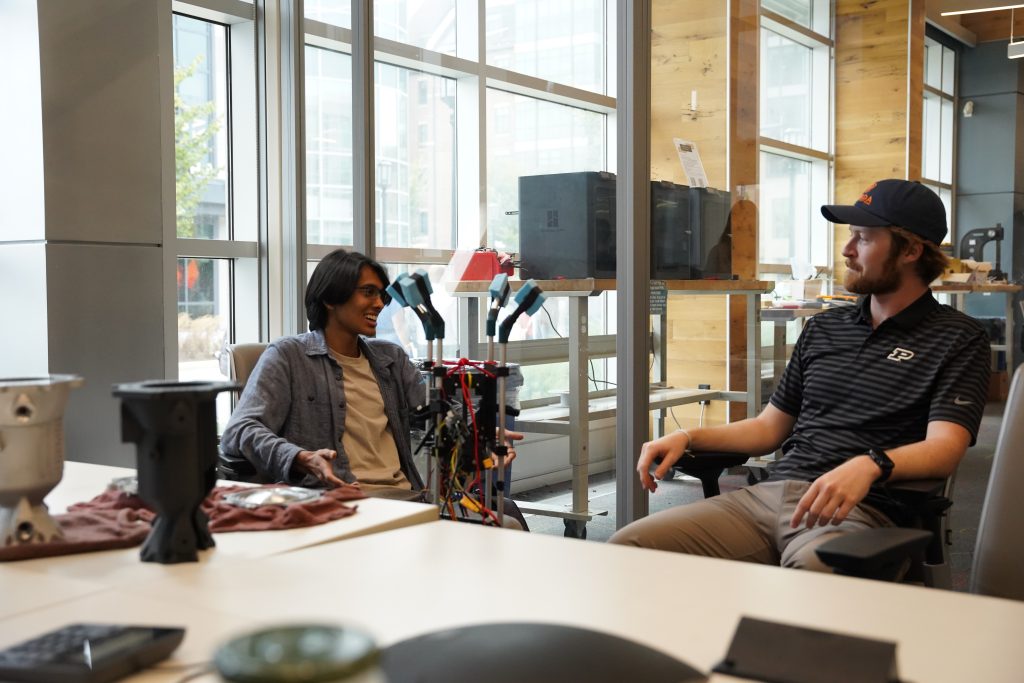 AC yap sesh Two students sit in chairs talking