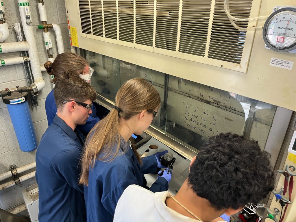 Spaceport fume hood A group of students work on a part under a fume hood